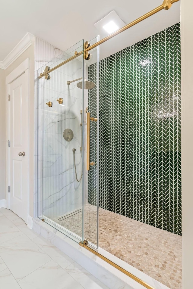 full bath with ornamental molding, a stall shower, and marble finish floor