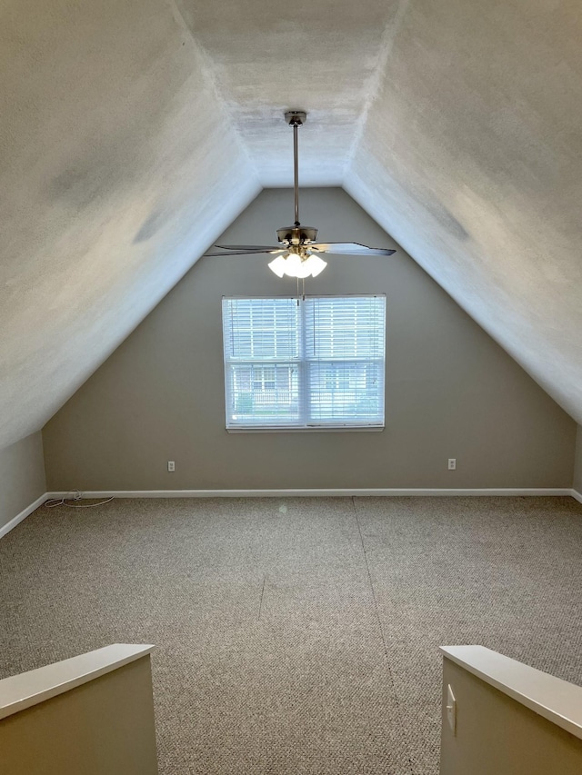 additional living space with vaulted ceiling and a textured ceiling