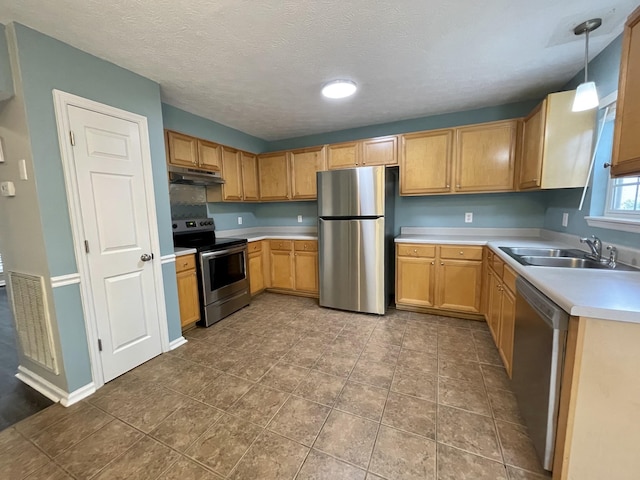 kitchen with stainless steel appliances, visible vents, light countertops, a sink, and under cabinet range hood