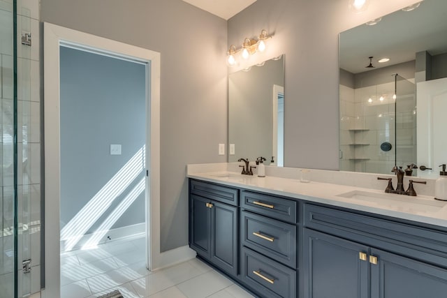 full bath with double vanity, a stall shower, and a sink