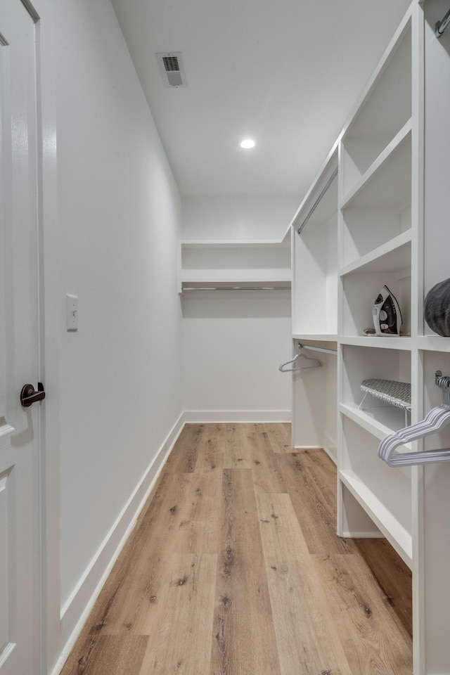 walk in closet featuring light wood-style flooring and visible vents