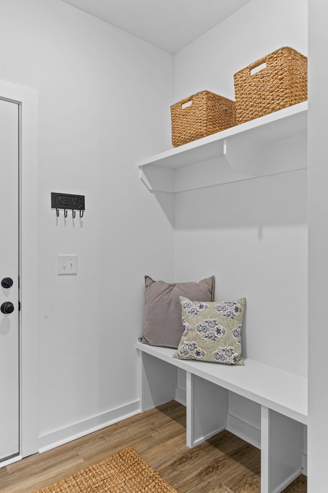 mudroom featuring baseboards and wood finished floors