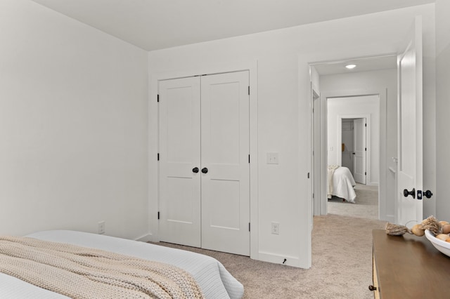 bedroom featuring carpet floors, a closet, and baseboards