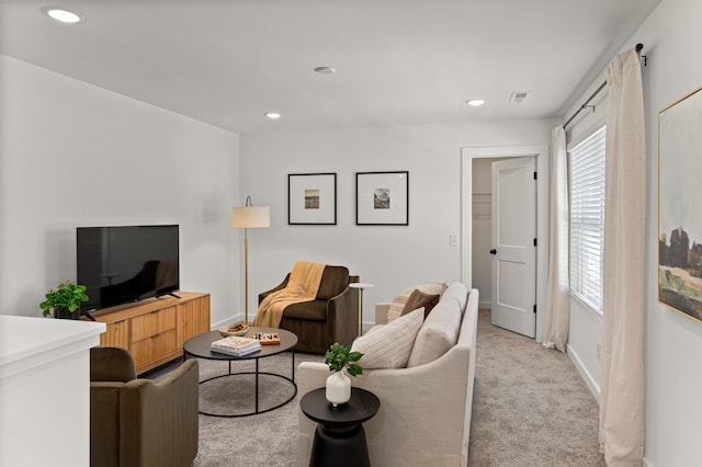 living room with recessed lighting, visible vents, baseboards, and light colored carpet