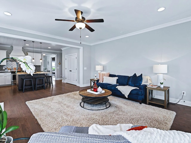 living room with crown molding, recessed lighting, dark wood finished floors, and baseboards