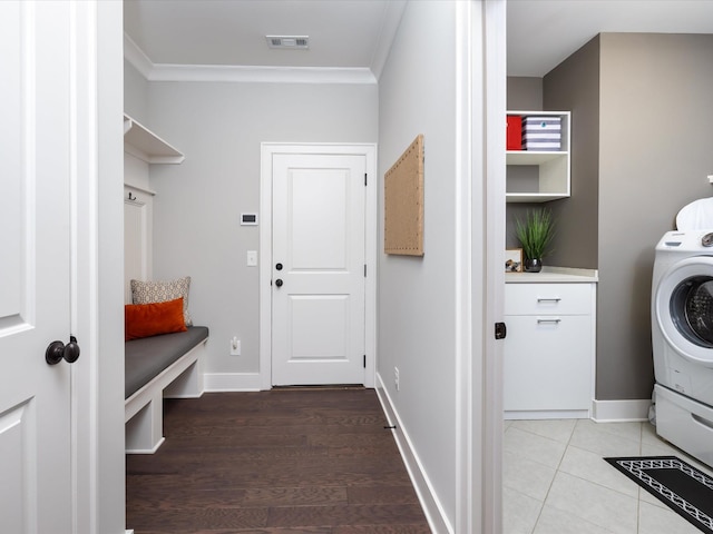 washroom featuring washer / dryer, laundry area, visible vents, and baseboards