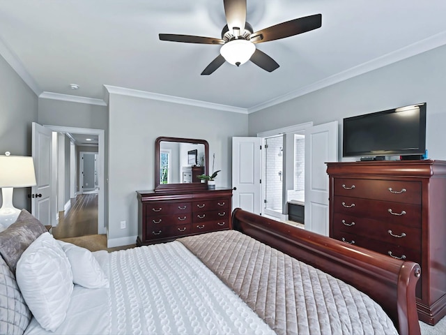 bedroom with crown molding, ensuite bath, baseboards, and ceiling fan