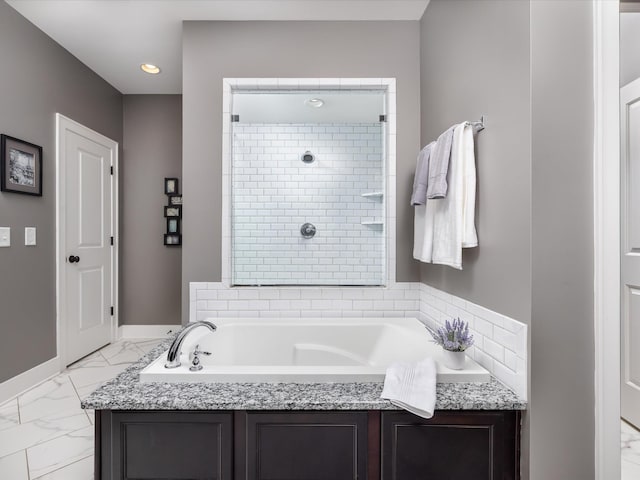 full bath with a garden tub, recessed lighting, baseboards, marble finish floor, and a tile shower