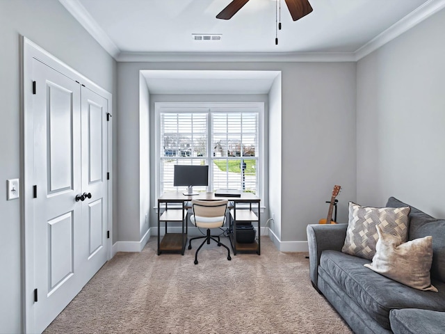 carpeted home office featuring ornamental molding, visible vents, baseboards, and a ceiling fan