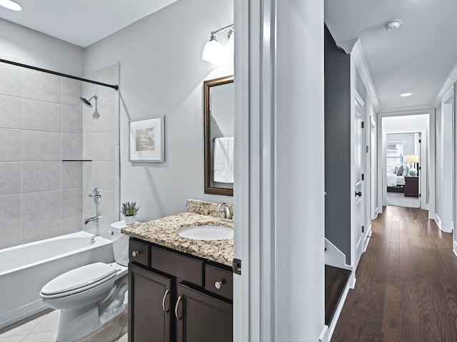 bathroom with shower / bathing tub combination, vanity, toilet, and wood finished floors