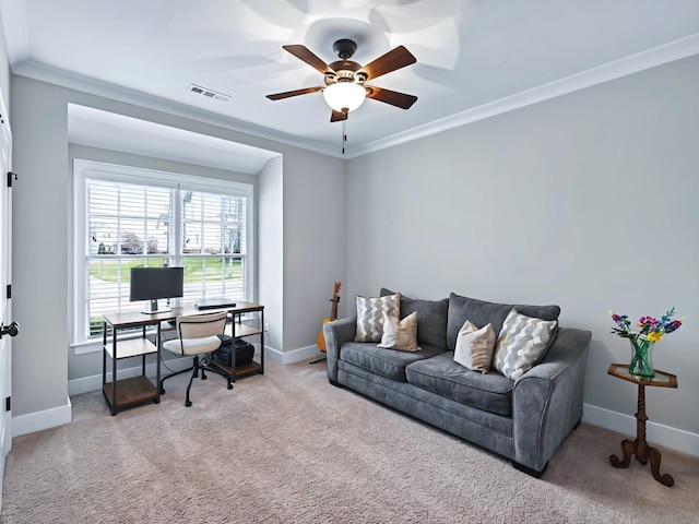 carpeted home office featuring visible vents, crown molding, baseboards, and ceiling fan