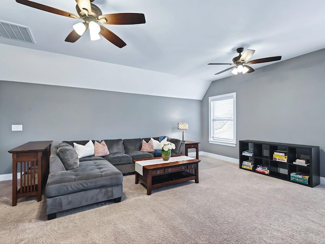 carpeted living area with lofted ceiling, baseboards, visible vents, and a ceiling fan