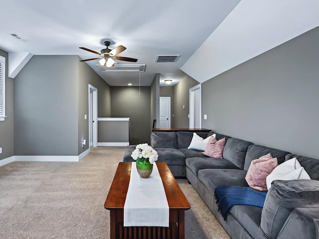 living room featuring light carpet, attic access, visible vents, and baseboards