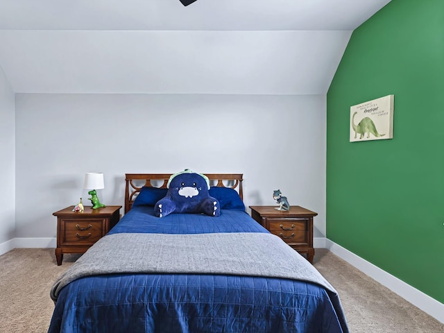 bedroom with carpet floors, baseboards, and vaulted ceiling