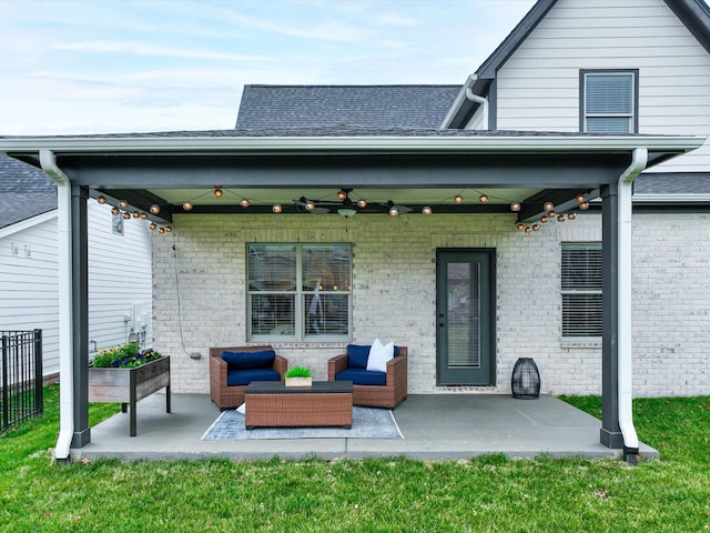 back of property with brick siding, a patio, and an outdoor living space