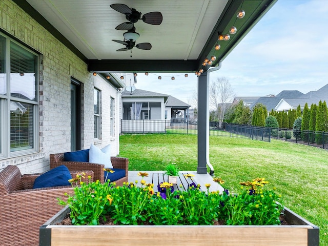 view of yard with ceiling fan and fence