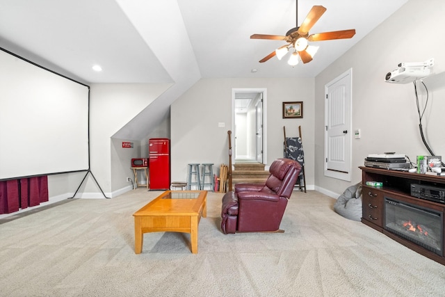 interior space featuring ceiling fan, recessed lighting, a glass covered fireplace, and baseboards