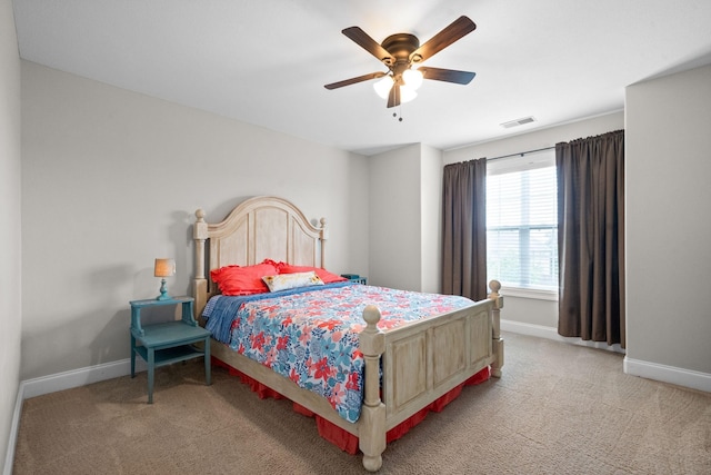 bedroom with a ceiling fan, visible vents, light carpet, and baseboards