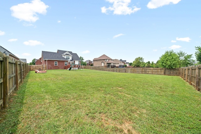 view of yard with a playground and a fenced backyard