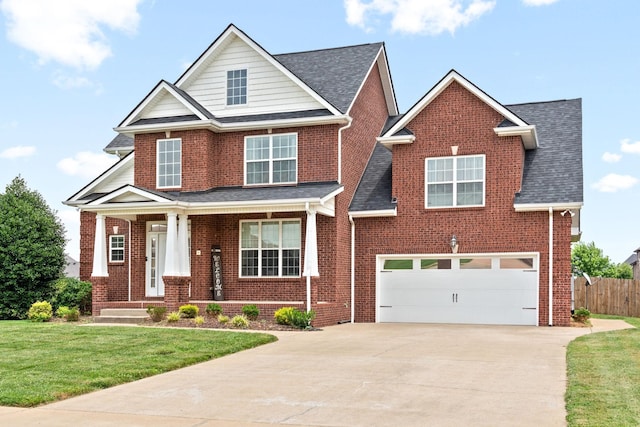 view of front of home with brick siding, concrete driveway, an attached garage, a front yard, and fence