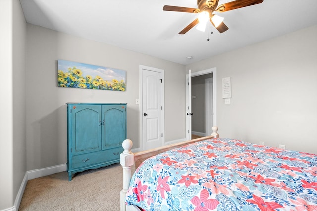 bedroom featuring ceiling fan, baseboards, and light colored carpet