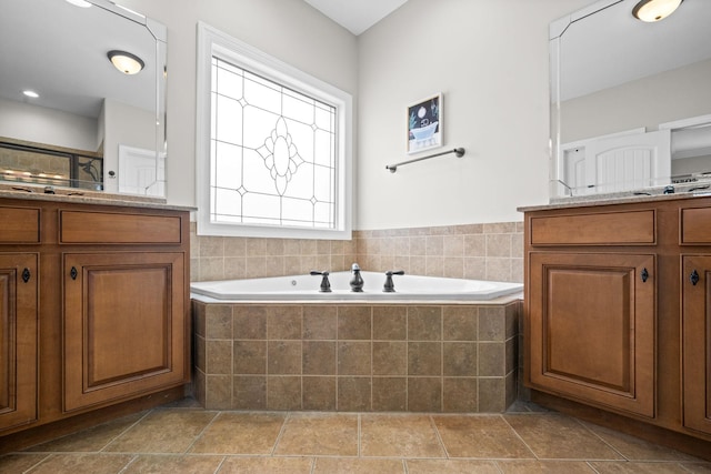 bathroom featuring walk in shower, a bath, and vanity