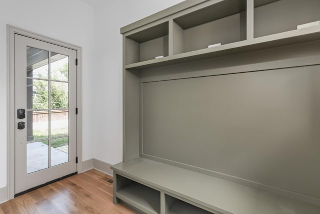 mudroom featuring light wood-style floors, plenty of natural light, and baseboards