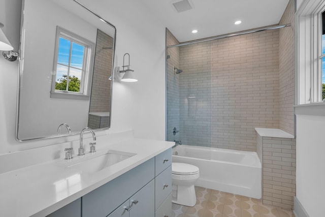 full bathroom with visible vents, shower / bathing tub combination, toilet, vanity, and recessed lighting