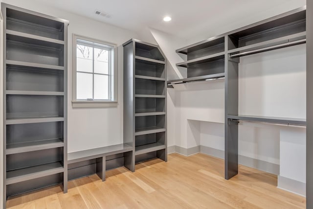 spacious closet with light wood-style flooring and visible vents