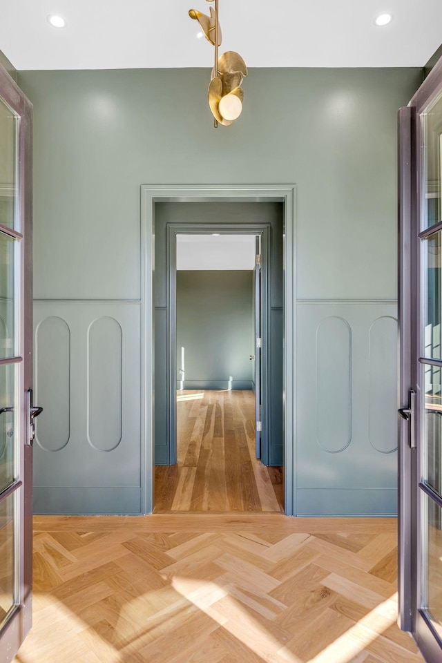 corridor featuring parquet floors and recessed lighting