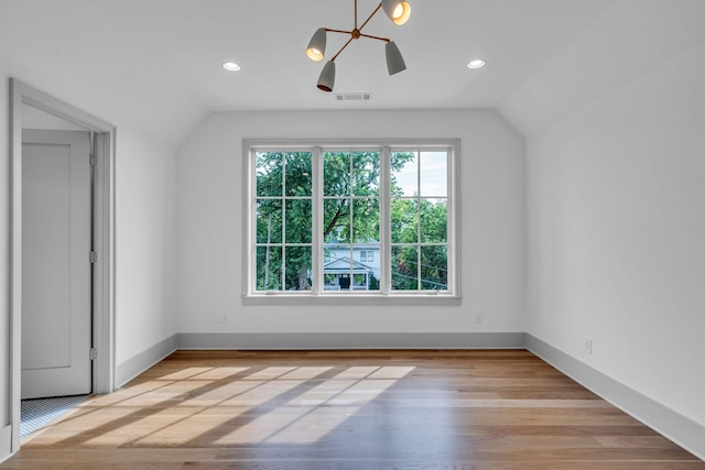 bonus room featuring vaulted ceiling, wood finished floors, visible vents, and baseboards