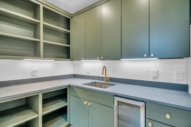 kitchen featuring beverage cooler, green cabinetry, a sink, and open shelves