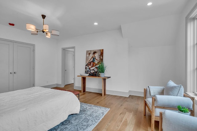 bedroom with light wood-style floors, baseboards, a chandelier, and recessed lighting