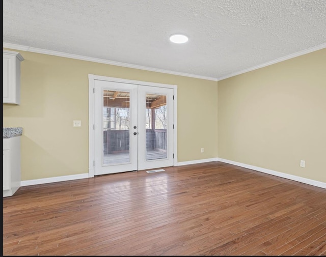 spare room with ornamental molding, french doors, and hardwood / wood-style floors