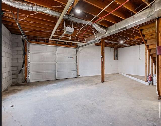 garage with electric panel and a garage door opener