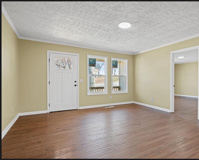 foyer featuring ornamental molding, hardwood / wood-style flooring, and baseboards