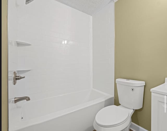 bathroom with a textured ceiling, shower / washtub combination, vanity, and toilet