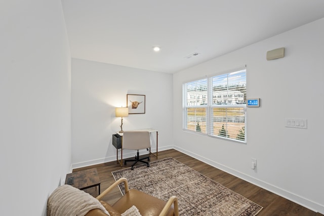 interior space with visible vents, dark wood finished floors, and baseboards