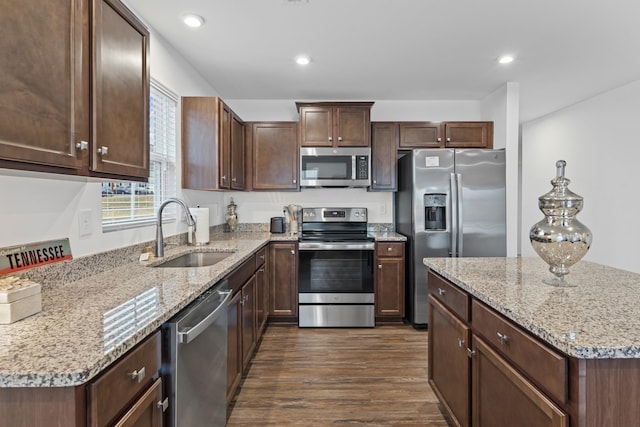 kitchen featuring stainless steel appliances, recessed lighting, a sink, and dark wood-style floors