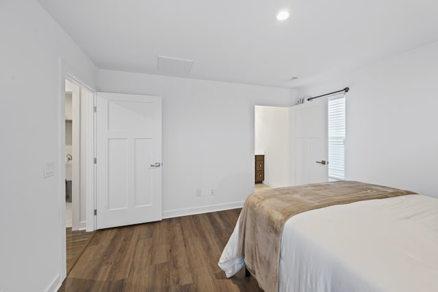 bedroom with wood finished floors and baseboards