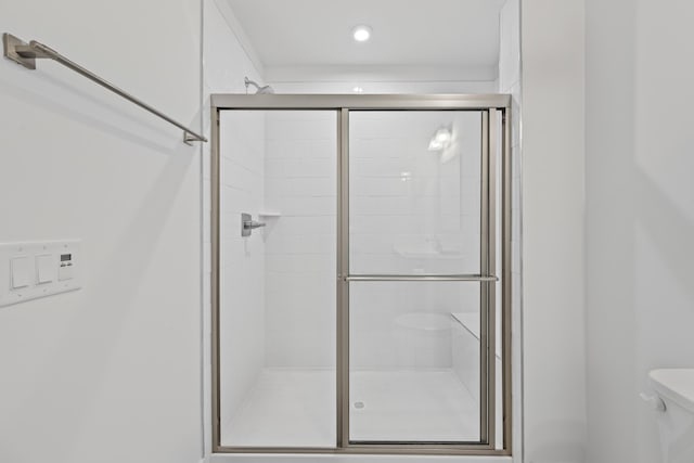 full bathroom featuring toilet and a stall shower