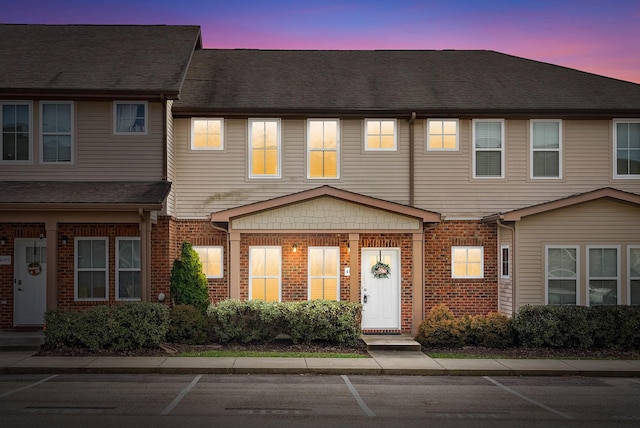 townhome / multi-family property featuring brick siding