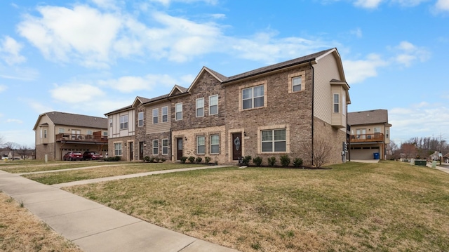 multi unit property with brick siding and a front lawn