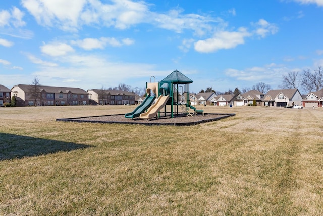 community playground with a lawn and a residential view