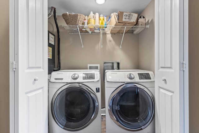 clothes washing area with laundry area and washing machine and clothes dryer