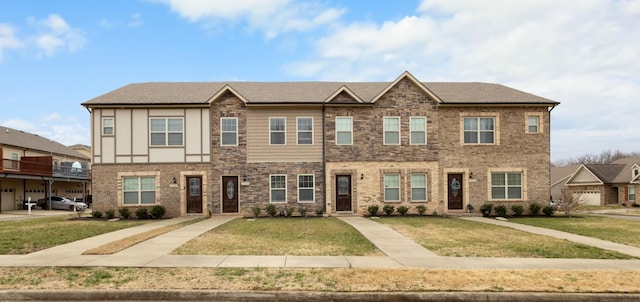 view of property with a front lawn and brick siding