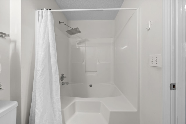 full bathroom with a shower with curtain, a textured ceiling, and toilet