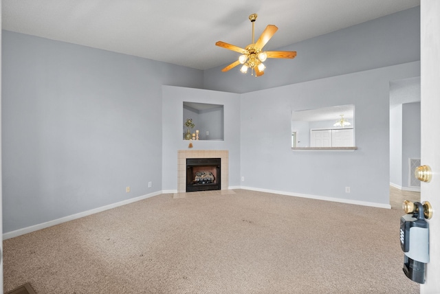 unfurnished living room with ceiling fan, a fireplace, carpet flooring, and baseboards