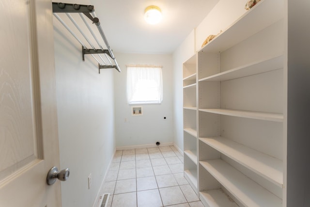 laundry area with laundry area, light tile patterned floors, visible vents, hookup for an electric dryer, and washer hookup