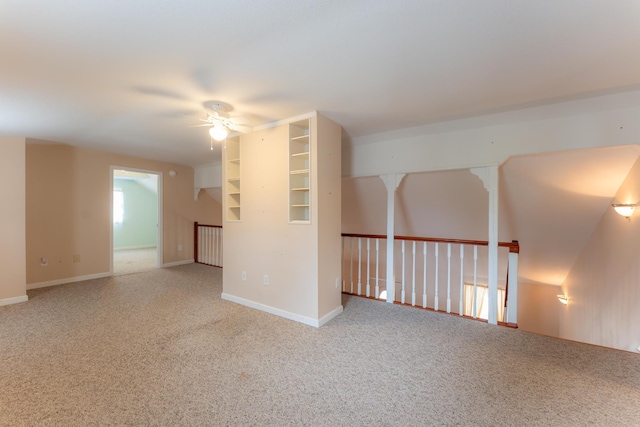 carpeted empty room featuring ceiling fan and baseboards